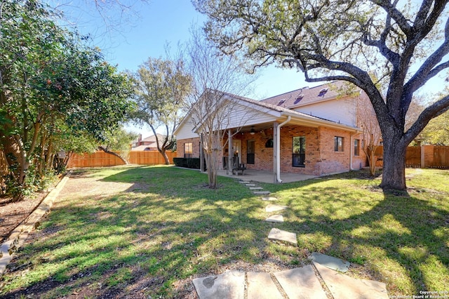 view of yard with ceiling fan and a patio area