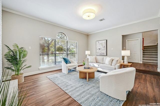 living room featuring dark hardwood / wood-style flooring and ornamental molding