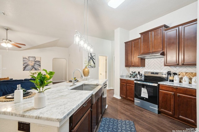 kitchen featuring dark wood-type flooring, a kitchen island with sink, decorative backsplash, decorative light fixtures, and stainless steel range with electric cooktop