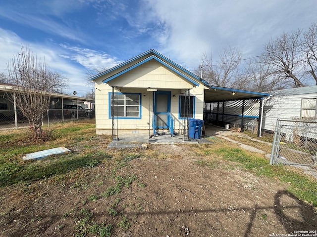 view of front of home featuring a carport and a porch