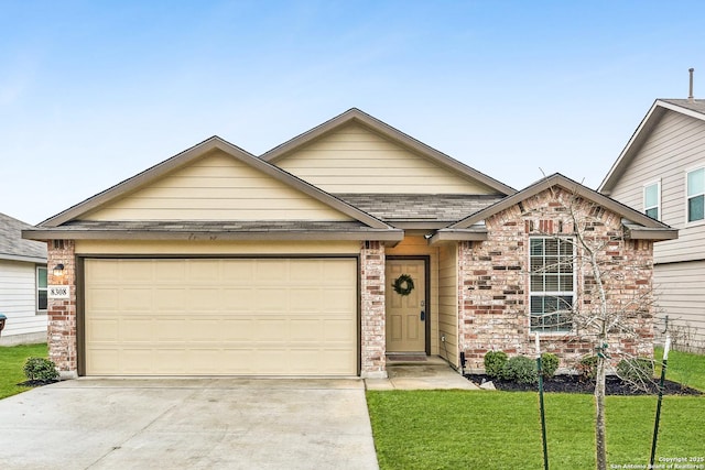 view of front of home featuring a garage and a front lawn