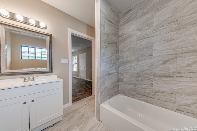 full bathroom featuring marble finish floor, baseboards, and vanity