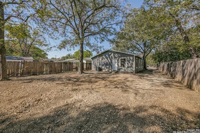 view of yard with a fenced backyard and central air condition unit