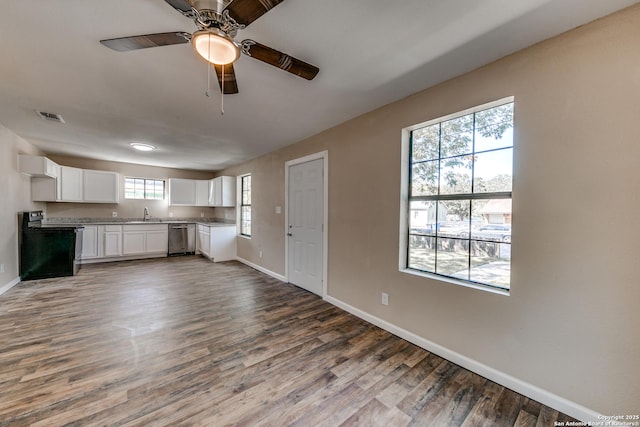 kitchen featuring stainless steel dishwasher, white cabinetry, dark wood finished floors, and electric range oven