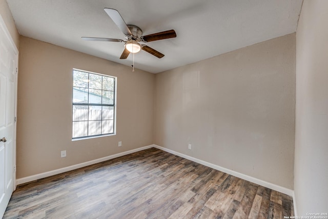 spare room with a ceiling fan, baseboards, and wood finished floors