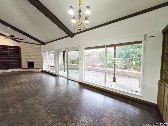 unfurnished living room with beam ceiling, plenty of natural light, and dark parquet flooring