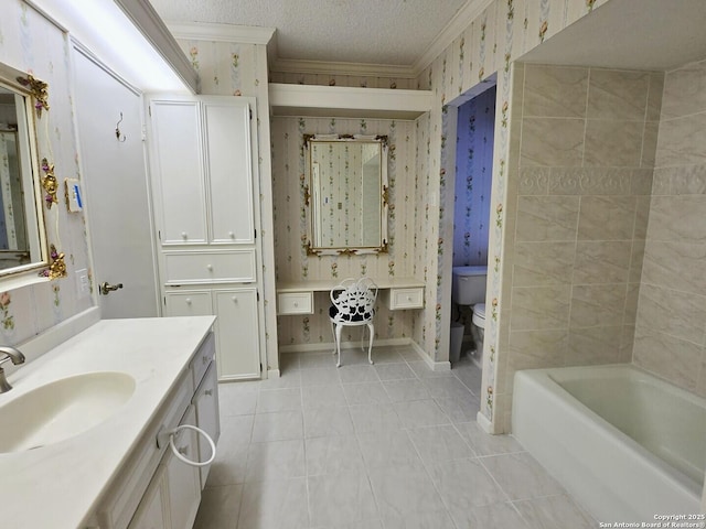 bathroom featuring vanity, a washtub, toilet, crown molding, and a textured ceiling