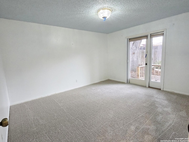 unfurnished room with carpet floors and a textured ceiling