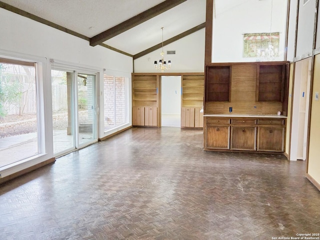 unfurnished living room with beamed ceiling, high vaulted ceiling, dark parquet floors, and a notable chandelier