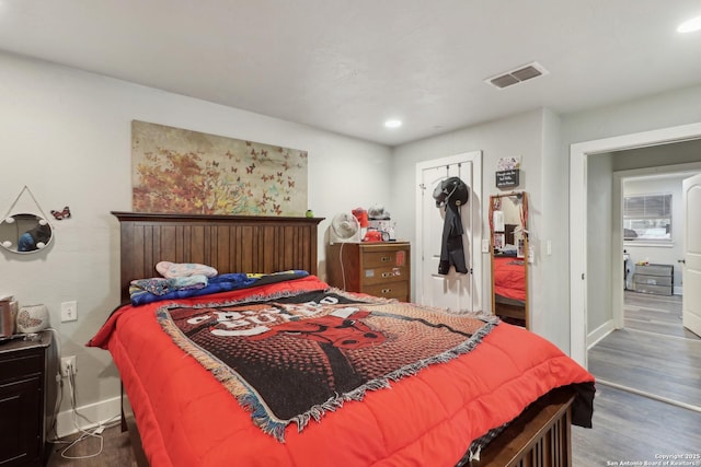 bedroom with dark wood-type flooring