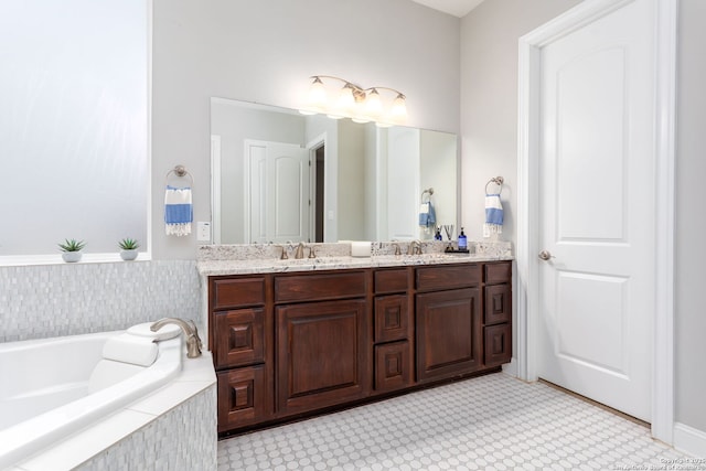 bathroom featuring vanity and tiled bath