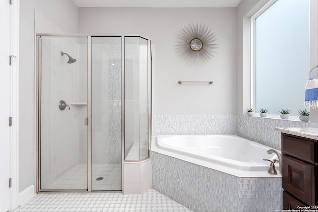 bathroom featuring vanity and independent shower and bath