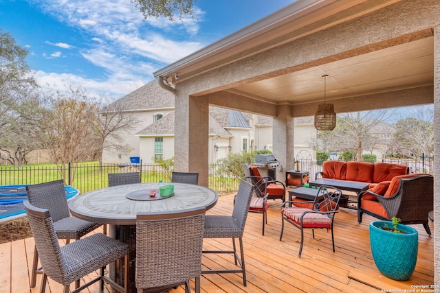 wooden deck featuring an outdoor living space and a grill