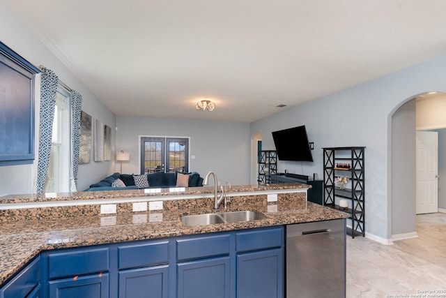 kitchen with sink, dishwasher, dark stone countertops, blue cabinets, and french doors