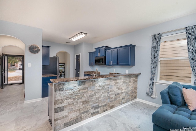 kitchen featuring blue cabinets and kitchen peninsula