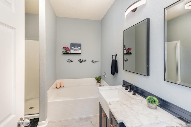 bathroom featuring vanity and separate shower and tub