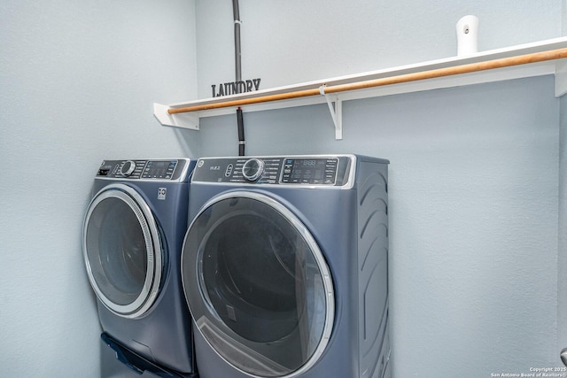 washroom featuring washer and dryer