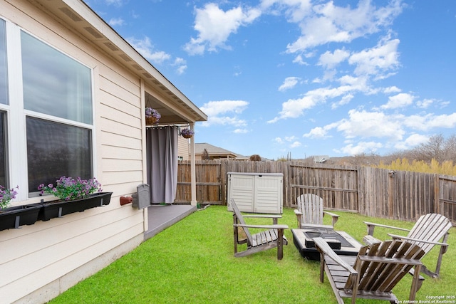 view of yard with a fire pit