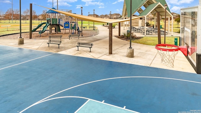 view of basketball court featuring a playground