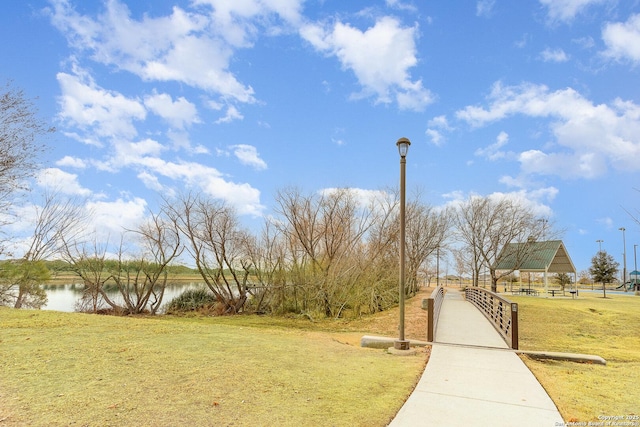 view of community with a yard, a gazebo, and a water view