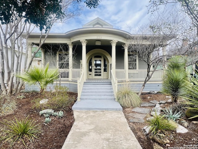 view of exterior entry featuring a porch