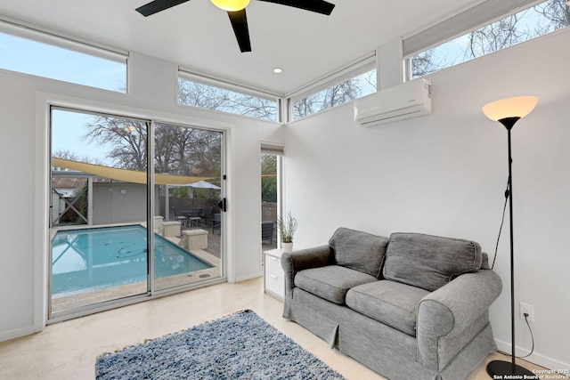 living room with ceiling fan and an AC wall unit