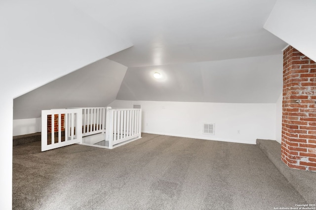 additional living space with vaulted ceiling and carpet