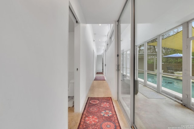 corridor with floor to ceiling windows