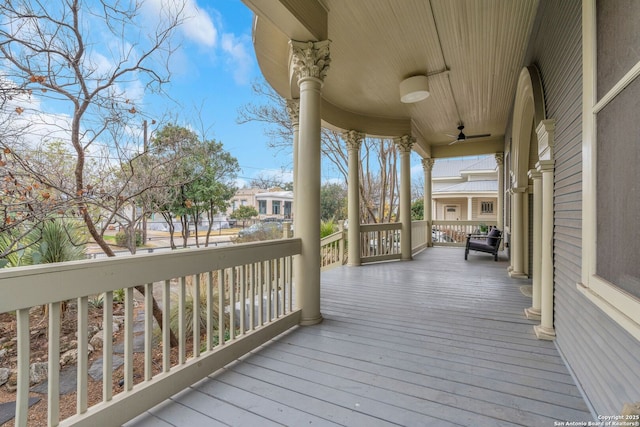 wooden deck with a porch and ceiling fan