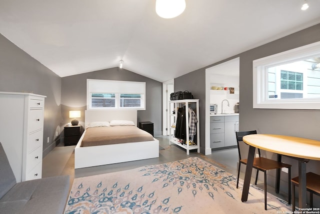 bedroom featuring lofted ceiling and sink