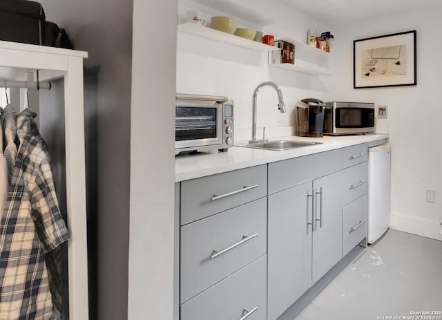 kitchen featuring gray cabinets and sink