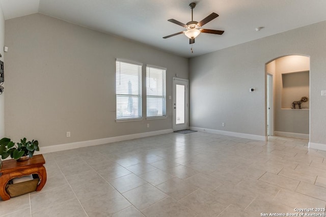 unfurnished room featuring light tile patterned flooring, vaulted ceiling, and ceiling fan