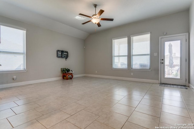 tiled empty room with lofted ceiling and ceiling fan