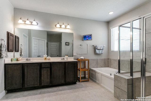 bathroom featuring tile patterned floors, vanity, and a bathing tub