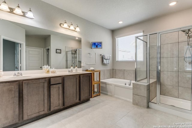 bathroom with tile patterned flooring, vanity, and separate shower and tub