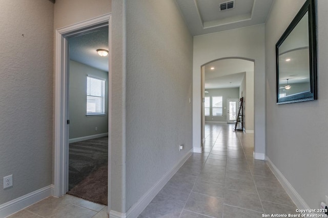 corridor with light tile patterned floors