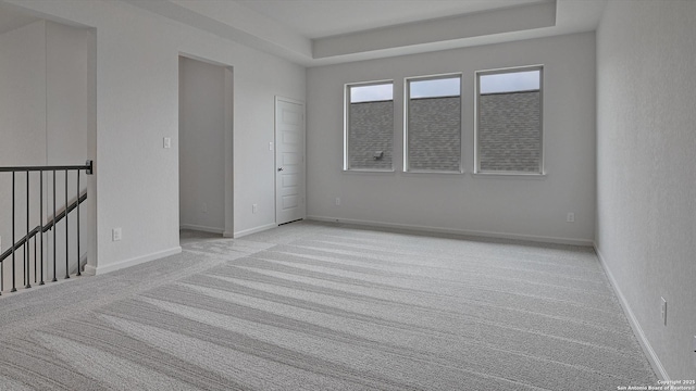 9722 Slick Frk, San Antonio, TX 78254 - unfurnished room featuring light colored carpet, a tray ceiling, and baseboards