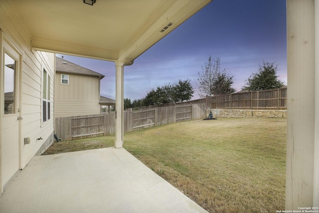 yard at dusk with a patio