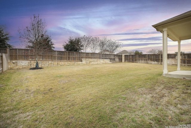 view of yard at dusk