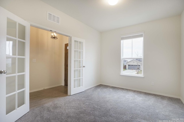 carpeted empty room with french doors