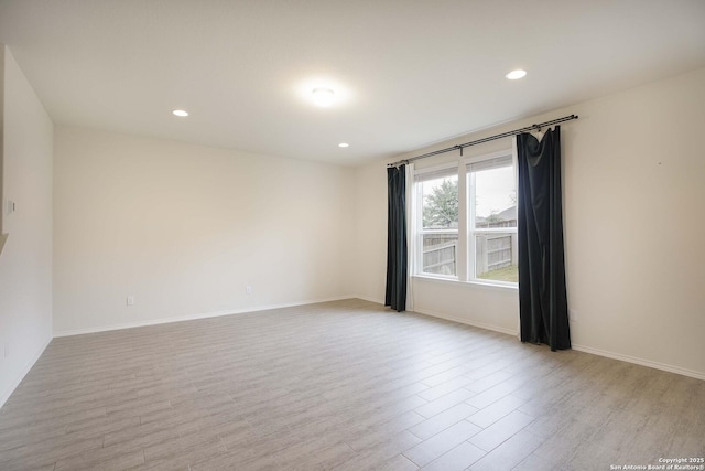 spare room with light hardwood / wood-style floors