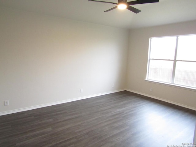 unfurnished room featuring dark hardwood / wood-style floors and ceiling fan