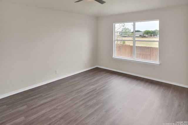 spare room with ceiling fan and dark hardwood / wood-style floors