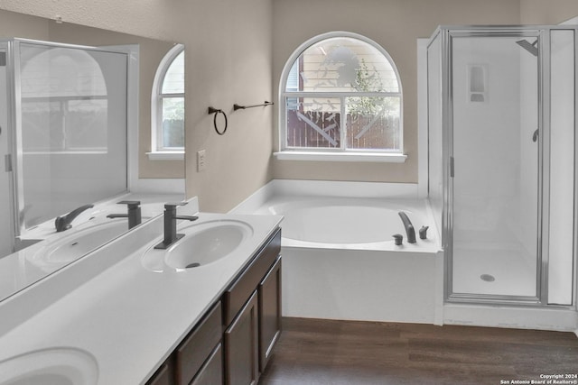 bathroom with vanity, independent shower and bath, and wood-type flooring