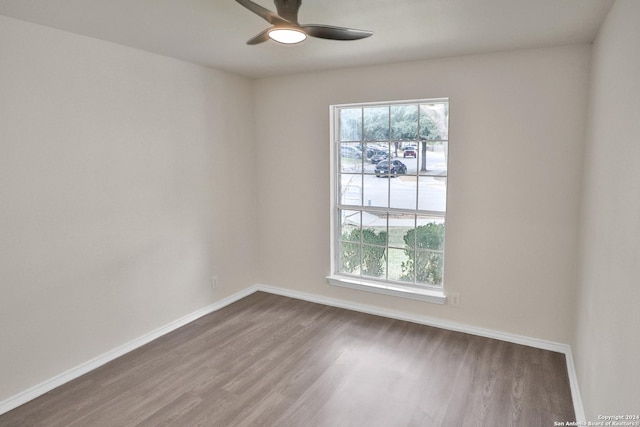 empty room with hardwood / wood-style flooring and ceiling fan