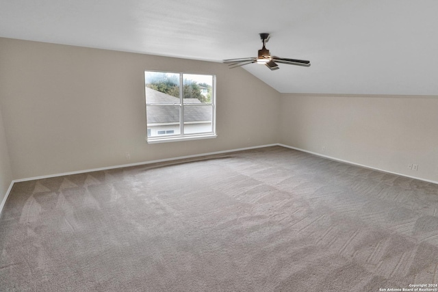 additional living space featuring ceiling fan, light colored carpet, and lofted ceiling