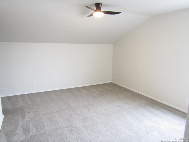 additional living space featuring lofted ceiling, ceiling fan, and carpet flooring