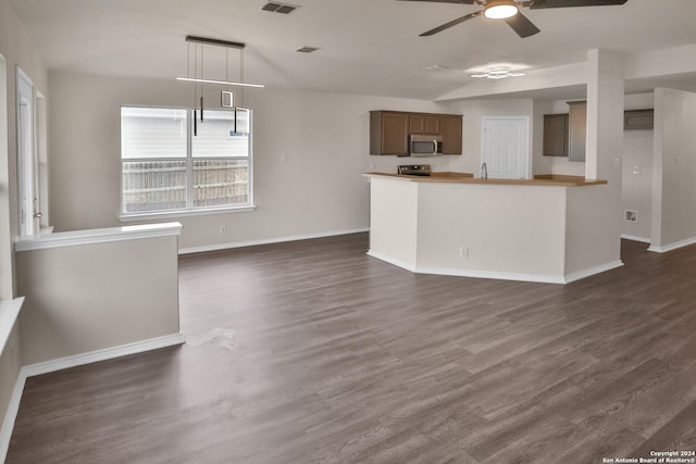 kitchen featuring hanging light fixtures, vaulted ceiling, dark hardwood / wood-style floors, and ceiling fan