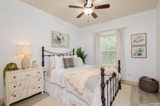 bedroom with ceiling fan and light hardwood / wood-style flooring