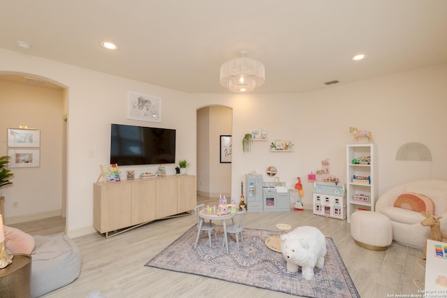 rec room with light hardwood / wood-style floors